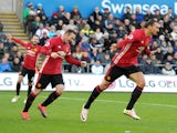 Manchester United striker Zlatan Ibrahimovic celebrates with Wayne Rooney following his goal during the Premier League clash with Swansea City at the Liberty Stadium on November 6, 2016