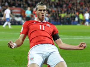 Bale makes history in Giggs's first game
