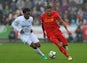 Swansea City midfielder Leroy Fer chases Liverpool's Roberto Firmino during the Premier League clash between the two sides on October 1, 2016