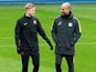 Kevin De Bruyne shares a joke with Pep Guardiola during a Manchester City training session on November 22, 2016