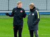 Kevin De Bruyne shares a joke with Pep Guardiola during a Manchester City training session on November 22, 2016
