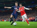Thomas Meunier and Mesut Ozil in action during the Champions League game between Arsenal and PSG on November 23, 2016