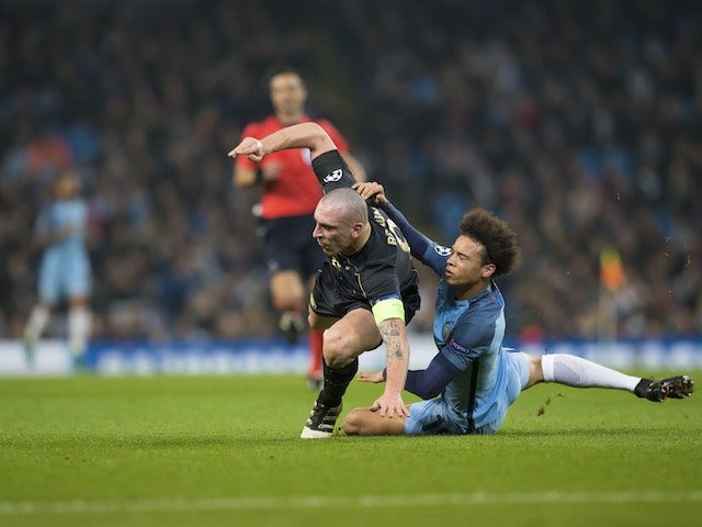 Leroy Sane and Scott Brown fight for the ball during the Champions League game between Manchester City and Celtic on December 6, 2016