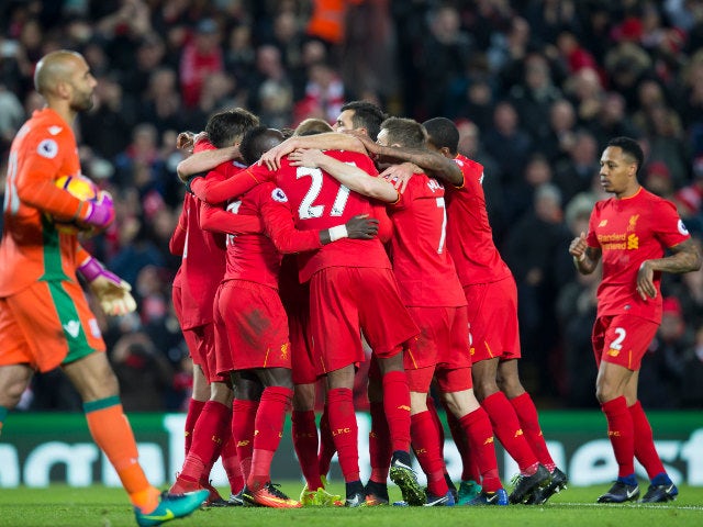 Liverpool players celebrate after an own goal by Stoke City's Giannelli Imbula during the Premier League clash between the two sides an Anfield on December 27, 2016