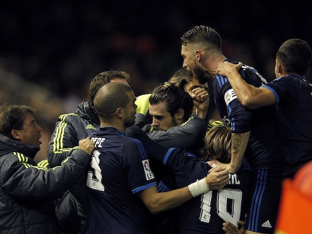 Gareth Bale is mobbed by teammates after scoring during the game between Valencia and Real Madrid on January 3, 2016