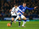 Ross Barkley gets his leg over Tom Carroll during the game between Everton and Tottenham Hotspur on January 3, 2016