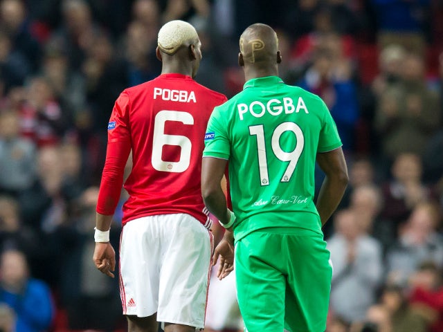 Manchester United midfielder Paul Pogba talks with brother and Saint-Etienne defender Florentin Pogba during the Europa League clash between the two sides at Old Trafford on February 16, 2017