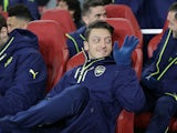 Mesut Ozil looks relaxed on the bench during the Champions League game between Arsenal and Bayern Munich on March 7, 2017