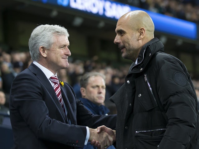 Pep Guardiola greets Mark Hughes ahead of the Premier League match between Manchester City and Stoke City on March 8, 2017