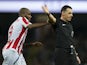 Stoke City's Saido Berahino grabs the arm of referee Neil Swarbrick during the Premier League match against Manchester City on March 8, 2017
