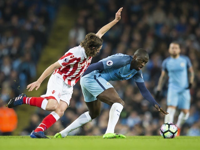 Manchester City's Yaya Toure and Stoke City's Joe Allen fight for the ball in the Premier League match on March 8, 2017
