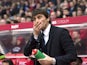 Antonio Conte cleans his face during the Premier League game between Stoke City and Chelsea on March 18, 2017