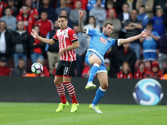 Dusan Tadic and Steve Cook during the Premier League match between Bournemouth and Southampton on April 1, 2017