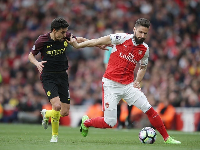 Jesus Navas and Olivier Giroud in action in the Premier League game between Arsenal and Manchester City on April 2, 2017