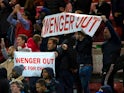 Arsenal fans hold up 'Wenger Out' signs during the Premier League clash with Middlesbrough at the Riverside Stadium on April 17, 2017