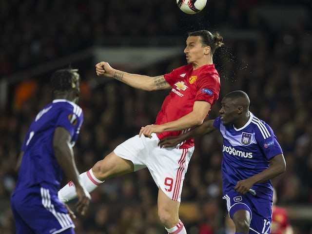 Zlatan Ibrahimovic tussles with Dennis Appiah and Kara Mbodji during the Europa League game between Manchester United and Anderlecht on April 20, 2017