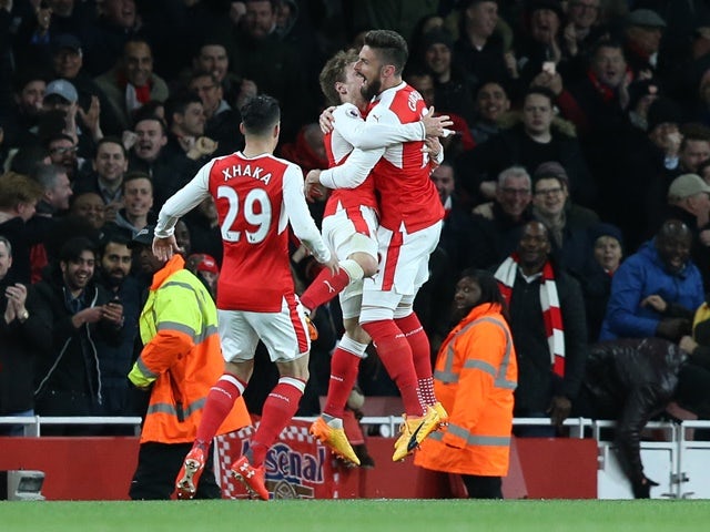 Arsenal players react to Robert Huth's own goal in the Premier League match against Leicester City on April 26, 2016
