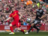 James Milner and Dusan Tadic in action during the Premier League game between Liverpool and Southampton on May 7, 2017