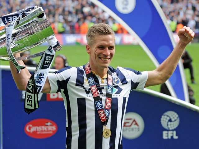 Millwall's Steve Morison holds the trophy after their League One playoff final victory over Bradford City on May 20, 2017