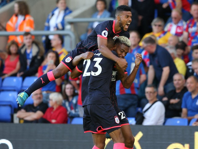 Elias Kachunga and Steve Mounie celebrate during the Premier League game between Crystal Palace and Huddersfield Town on August 12, 2017