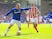 Wayne Rooney fends off Geoff Cameron during the Premier League game between Everton and Stoke City on August 12, 2017
