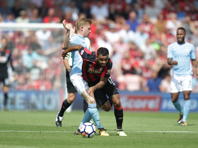 Joshua King attempts to manhandle Kevin De Bruyne during the Premier League game between Bournemouth and Manchester City on August 26, 2017