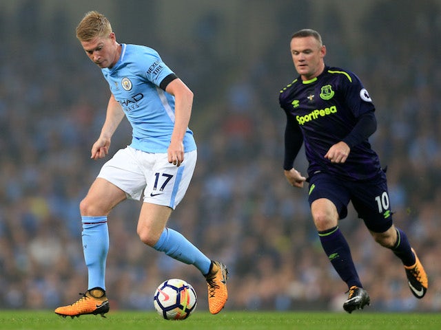 Kevin De Bruyne is pursued by Wayne Rooney during the Premier League game between Manchester City and Everton on August 21, 2017