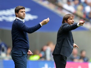Mauricio Pochettino and Antonio Conte give instructions during the Premier League game between Tottenham Hotspur and Chelsea on August 20, 2017