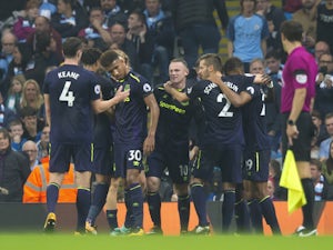 Wayne Rooney celebrates with teammates after scoring during the Premier League game between Manchester City and Everton on August 21, 2017