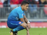 Alexis Sanchez sits dejected during the Premier League game between Liverpool and Arsenal on August 27, 2017