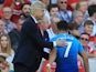 Arsene Wenger pats Alexis Sanchez on the back during the Premier League game between Liverpool and Arsenal on August 27, 2017