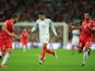 Malta players chase after Jesse Lingard in a match between England and Malta at Wembley