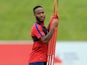 Raheem Sterling makes a friend during an England training session on August 29, 2017