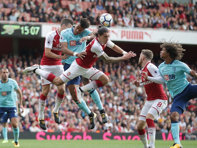 Hector Bellerin clears from Tyrone Mings during the Premier League game between Arsenal and Bournemouth on September 9, 2017