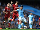Roberto Firmino battles with Sergio Aguero during the Premier League game between Manchester City and Liverpool on September 9, 2017