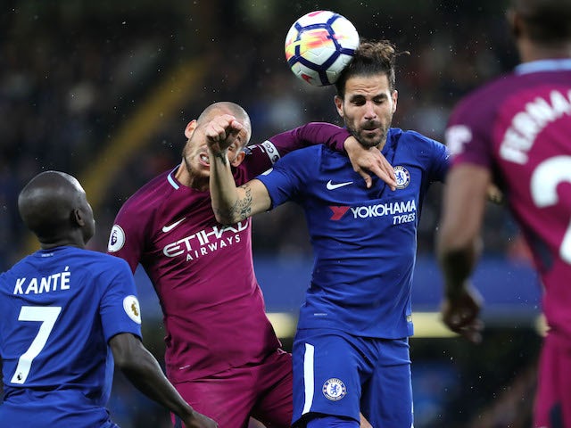 Cesc Fabregas beats David Silva to a header during the Premier League game between Chelsea and Manchester City on September 30, 2017
