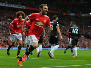 Manchester United midfielder Juan Mata wheels away in celebration after opening the scoring during the Premier League clash with Crystal Palace at Old Trafford on September 30, 2017