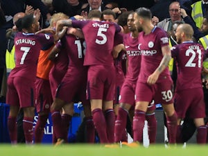 Kevin De Bruyne is mobbed by teammates after scoring during the Premier League game between Chelsea and Manchester City on September 30, 2017