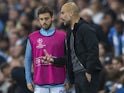 Pep Guardiola has a chat with Bernardo Silva during the Champions League game between Manchester City and Shakhtar Donetsk on September 26, 2017