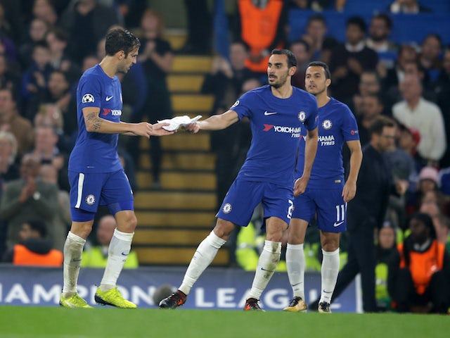 Davide Zappacosta hands a written note from Antonio Costa to Cesc Fabregas during the Champions League group game between Chelsea and Roma on October 18, 2017