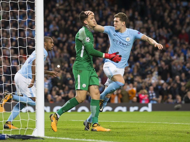 John Stones pats Ederson on the head after he saves a penalty during the Champions League group game between Manchester City and Napoli on October 17, 2017
