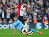 Mikel Merino tackles Charlie Austin during the Premier League game between Southampton and Newcastle United on October 15, 2017