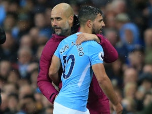 Pep Guardiola embraces Sergio Aguero during the Premier League game between Manchester City and Burnley on October 21, 2017