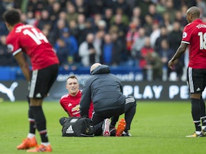 Phil Jones receives treatment during the Premier League game between Huddersfield Town and Manchester United on October 21, 2017