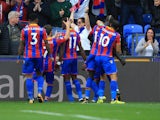 Wilfried Zaha celebrates with teammates after scoring during the Premier League game between Crystal Palace and Chelsea on October 14, 2017