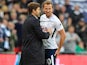 Harry Kane chats to Mauricio Pochettino during the Premier League game between Tottenham Hotspur and Liverpool on October 22, 2017