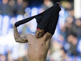 Jack Wilshere removes his shirt and gives it to a pitch invader during the Premier League game between Everton and Arsenal on October 22, 2017