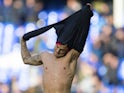 Jack Wilshere removes his shirt and gives it to a pitch invader during the Premier League game between Everton and Arsenal on October 22, 2017