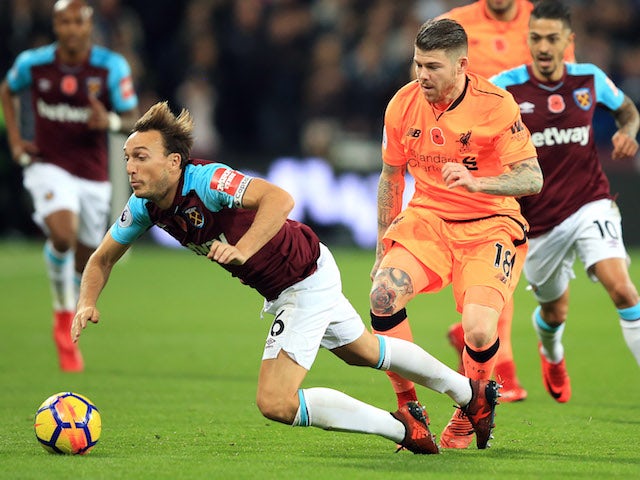 Alberto Moreno tackles Mark Noble during the Premier League game between West Ham United and Liverpool on November 4, 2017