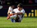 Harry Winks nurses an injured leg during the Premier League game between Tottenham Hotspur and Crystal Palace on November 5, 2017